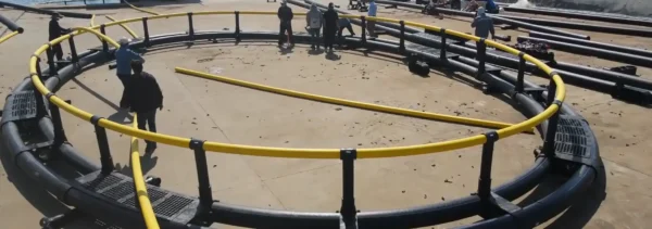 Certified welders performing 220 degree Celsius hydraulic thermofusion butt welding on HDPE aquaculture cage framework